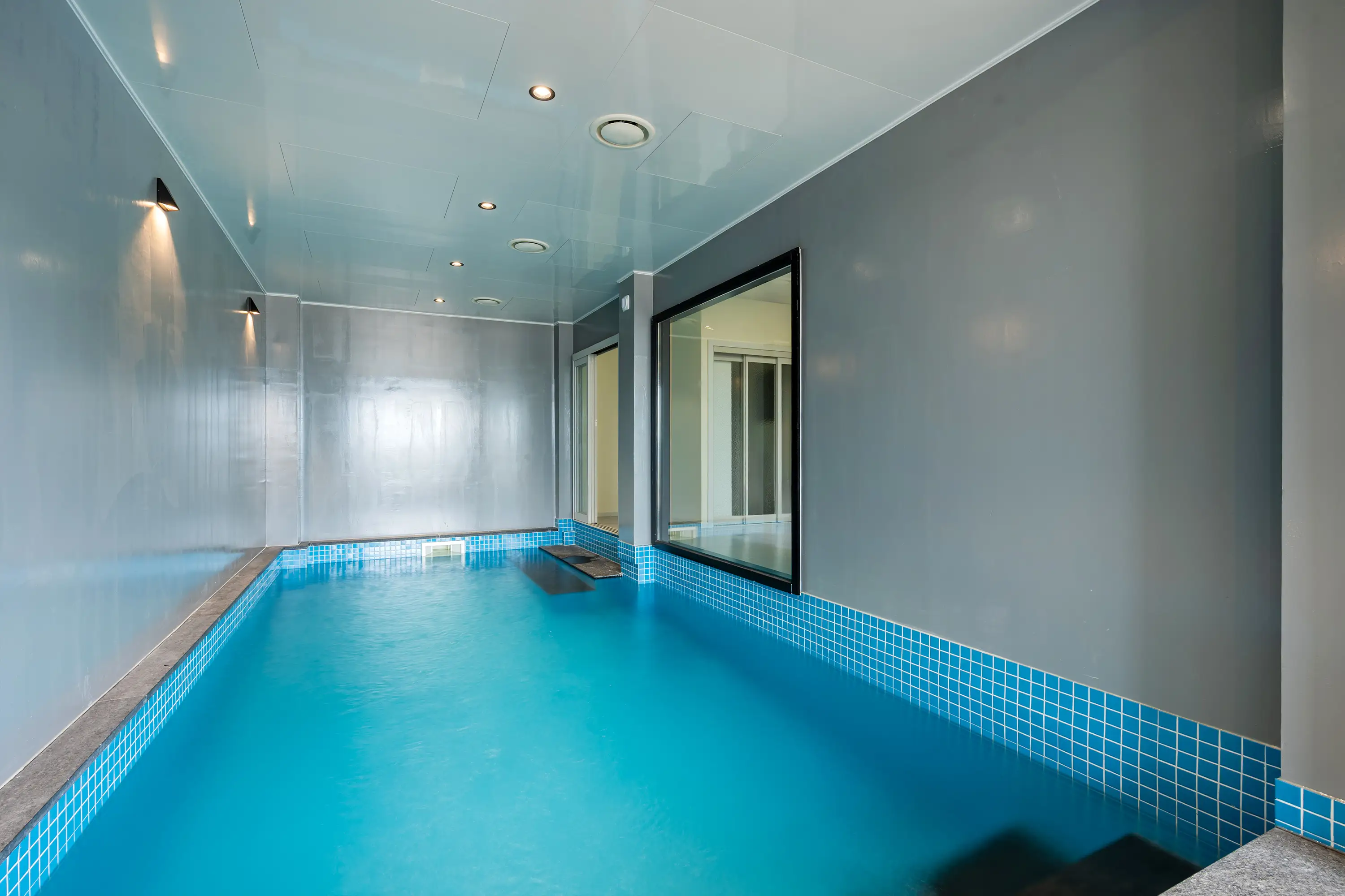Indoor pool with floor-to-ceiling windows